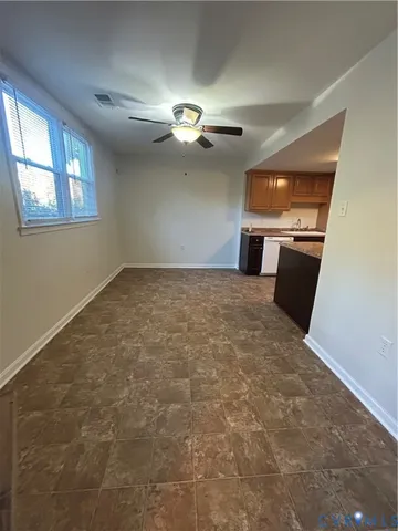 a view of a livingroom with a ceiling fan and window