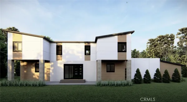 a front view of a house with a garden