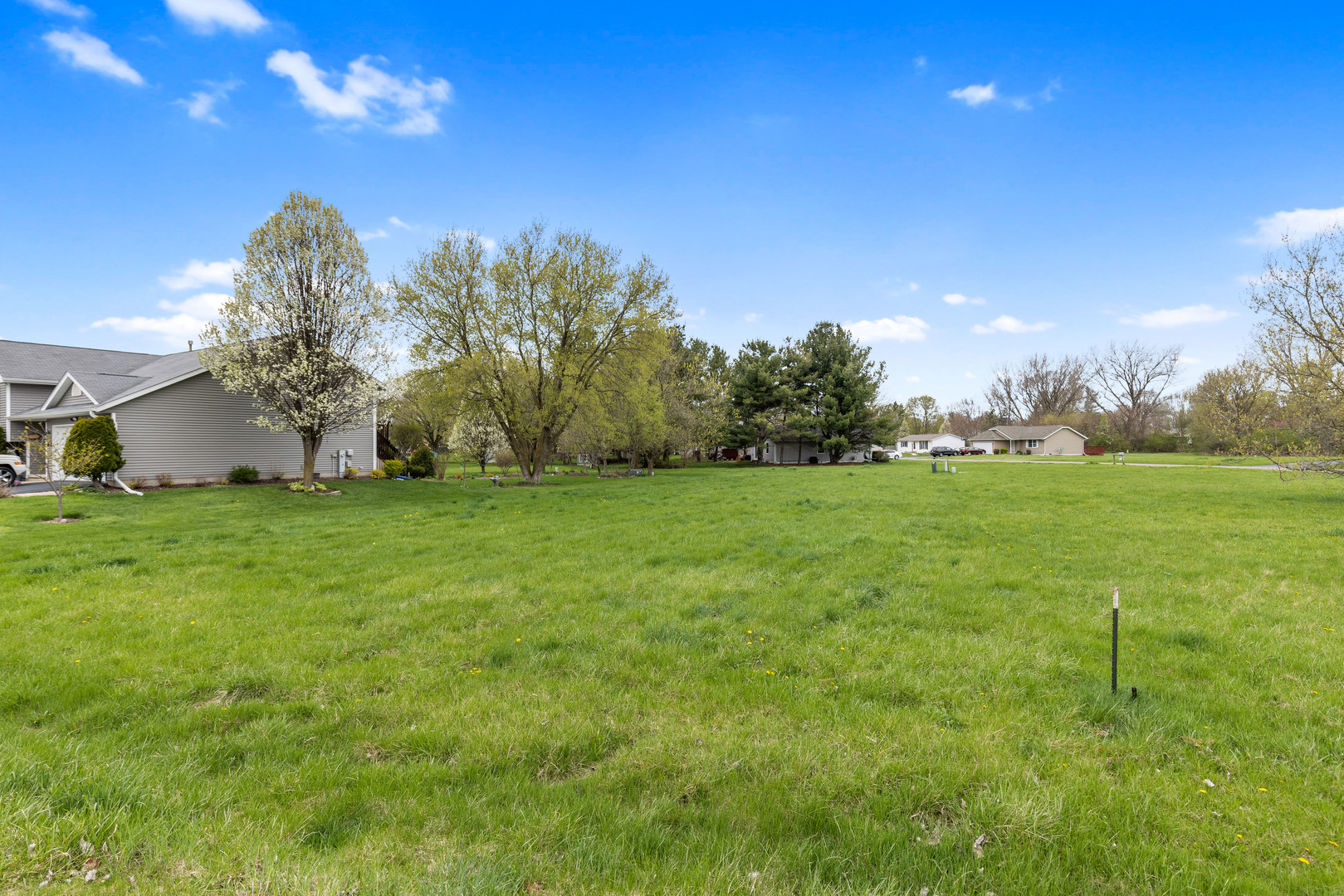 416 Benedict Drive Southwest Poplar Grove, IL 61065 - Photo 2 of 30 a backyard of a house with lots of green space