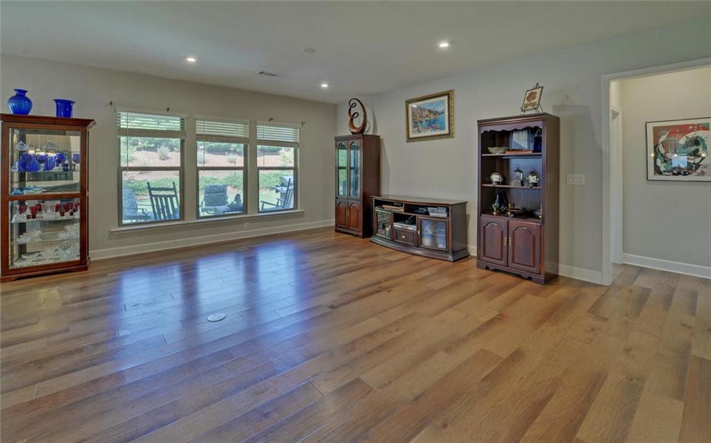 5825 Maple Bluff Way Hoschton, GA 30548 - Photo 12 of 67 a view of a livingroom with furniture wooden floor and window
