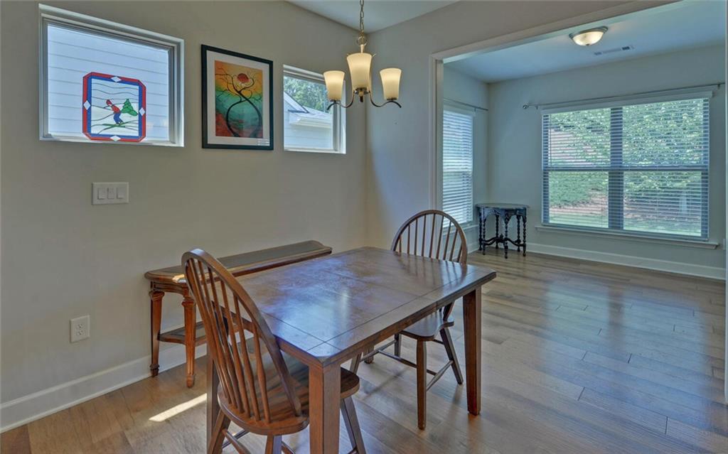 5825 Maple Bluff Way Hoschton, GA 30548 - Photo 20 of 67 a view of a dining room with furniture window and wooden floor