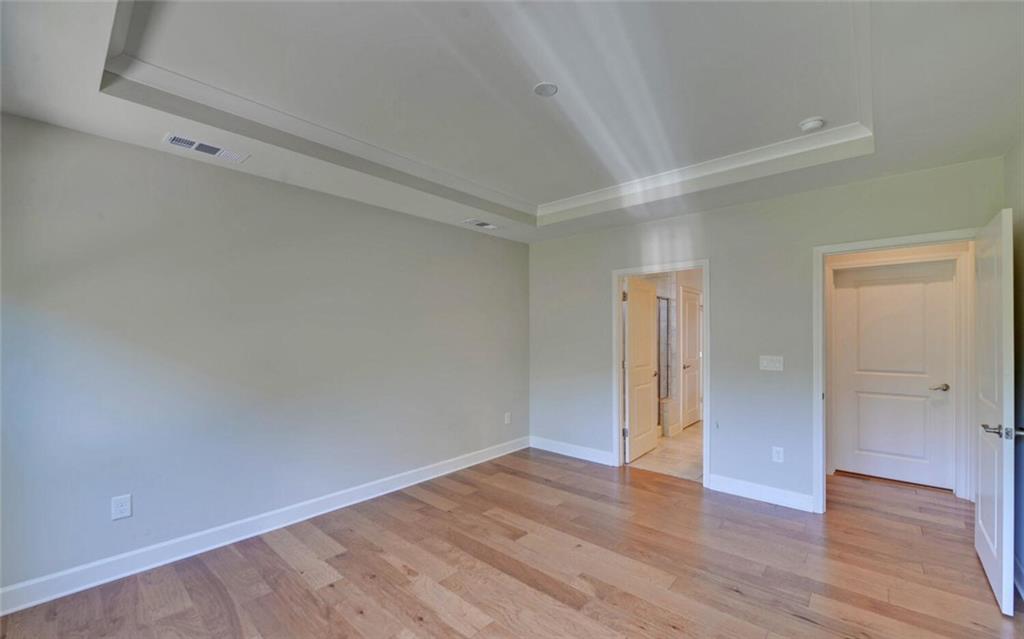 5825 Maple Bluff Way Hoschton, GA 30548 - Photo 25 of 67 a view of an empty room with wooden floor