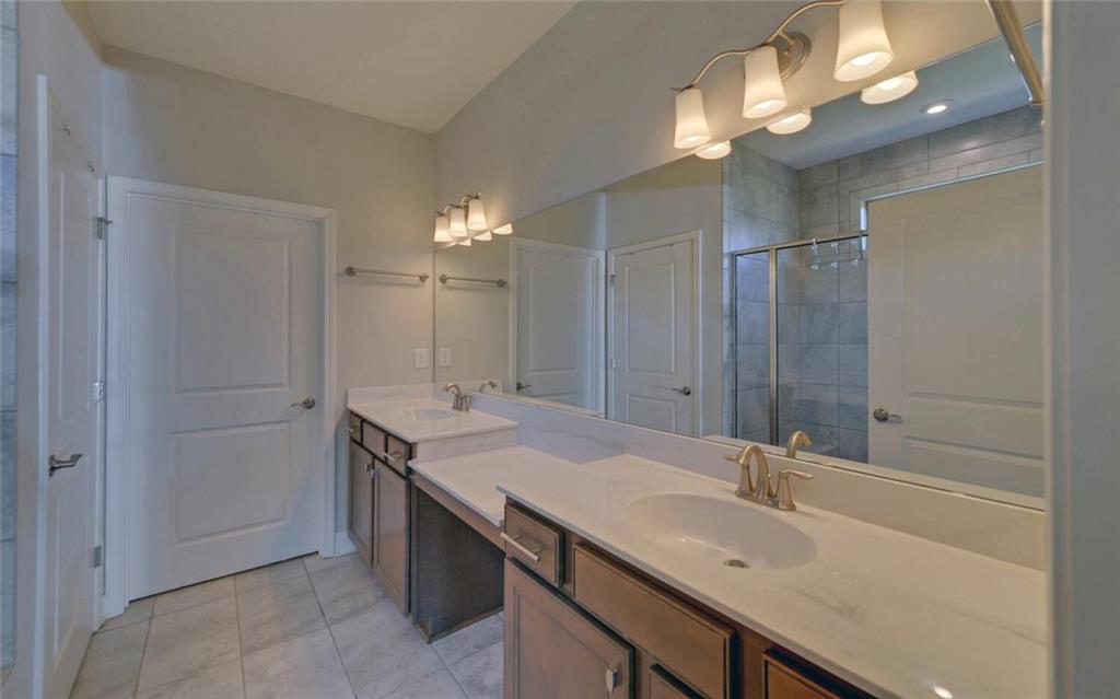 5825 Maple Bluff Way Hoschton, GA 30548 - Photo 28 of 67 a bathroom with a sink double vanity and a mirror
