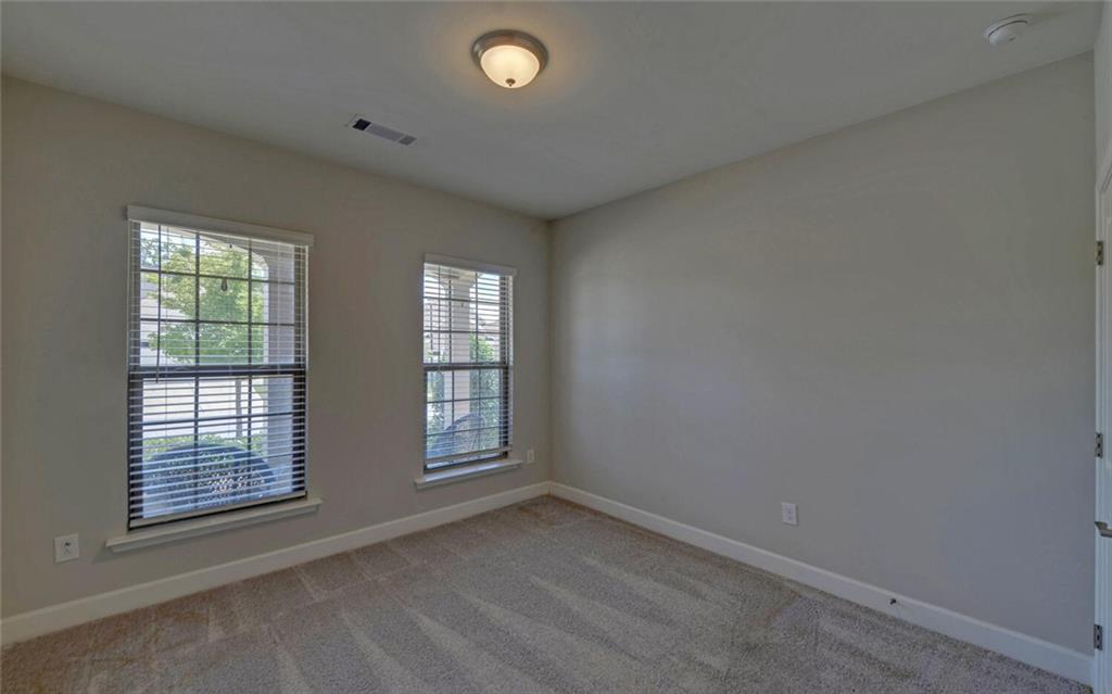5825 Maple Bluff Way Hoschton, GA 30548 - Photo 32 of 67 an empty room with windows