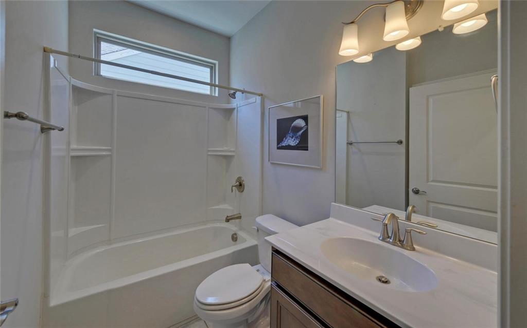 5825 Maple Bluff Way Hoschton, GA 30548 - Photo 36 of 67 a bathroom with a sink a toilet and shower