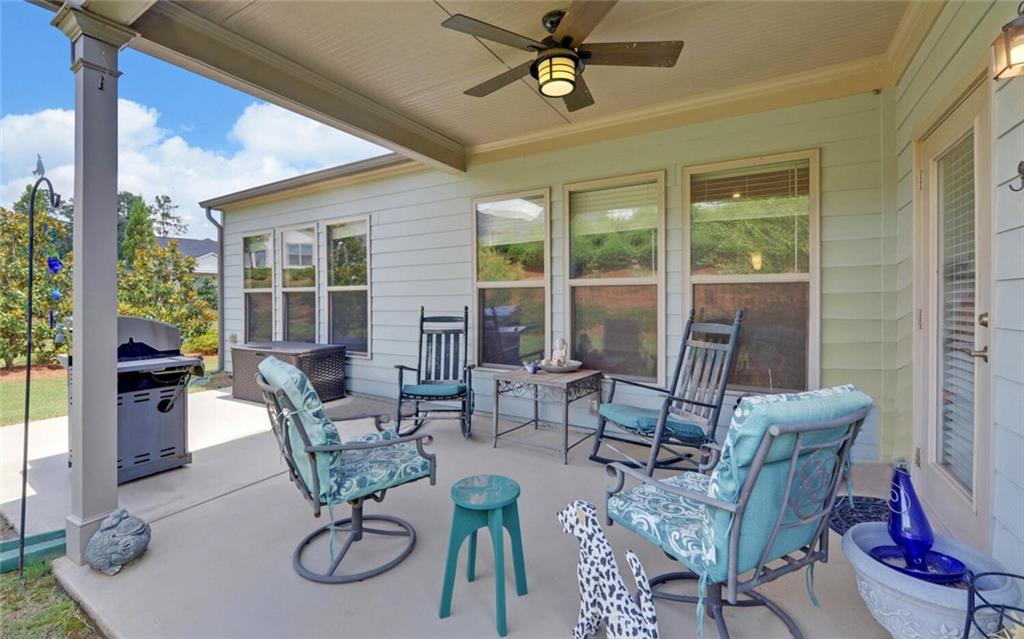 5825 Maple Bluff Way Hoschton, GA 30548 - Photo 42 of 67 a living room with furniture and a floor to ceiling window