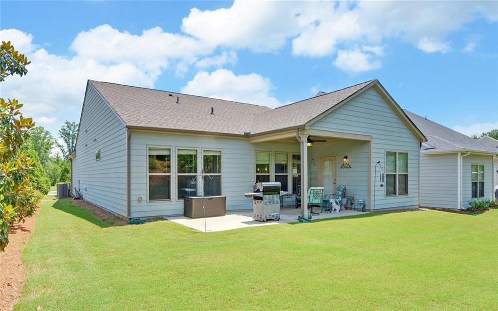 5825 Maple Bluff Way Hoschton, GA 30548 - Photo 44 of 67 a view of a house with a backyard and sitting area
