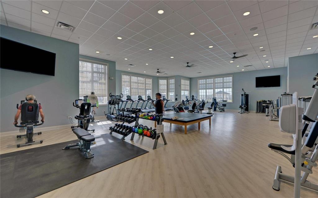5825 Maple Bluff Way Hoschton, GA 30548 - Photo 56 of 67 a view of a room with gym equipment and a flat screen tv