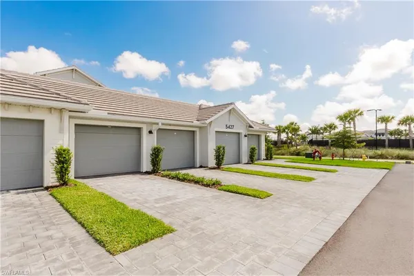 a front view of house with outdoor space and trees