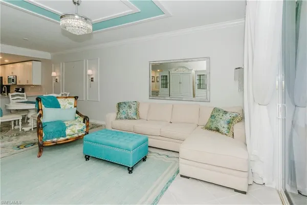 a living room with furniture and a chandelier