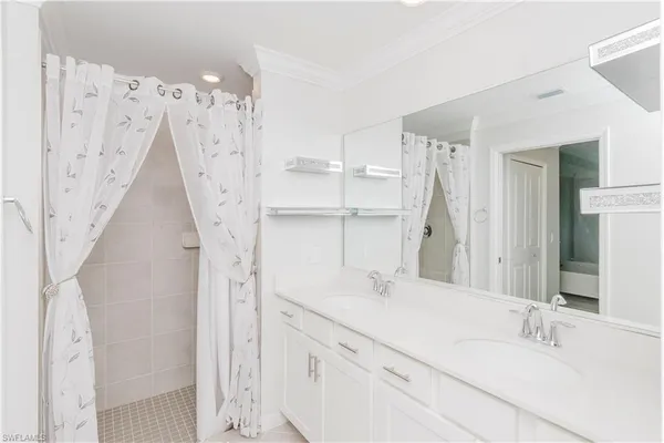 a bathroom with a double vanity sink and mirror