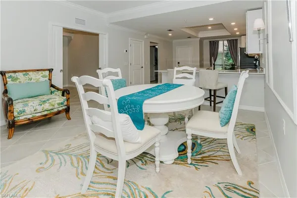 a living room with furniture and a dining table with kitchen view