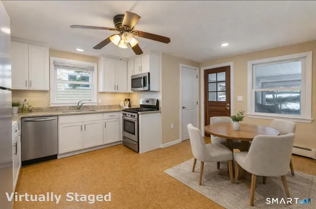 a kitchen with a white cabinets stove and refrigerator