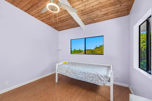 a bedroom with a bed and a painting on the wall