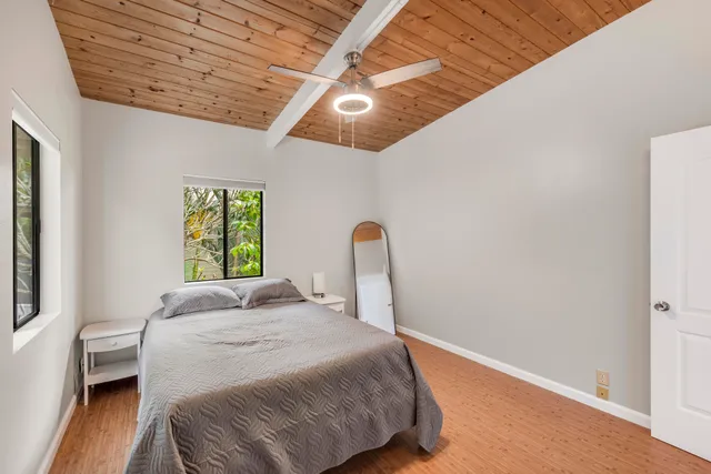 a bedroom with a bed next to a window