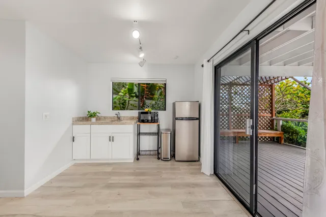 a view of a swimming pool with furniture and wooden floor