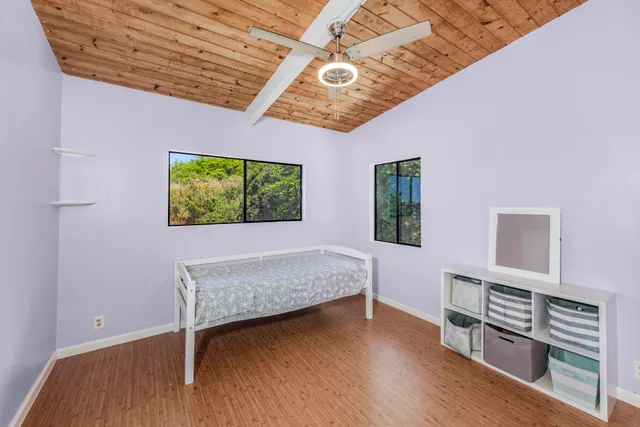 a bedroom with furniture and a window