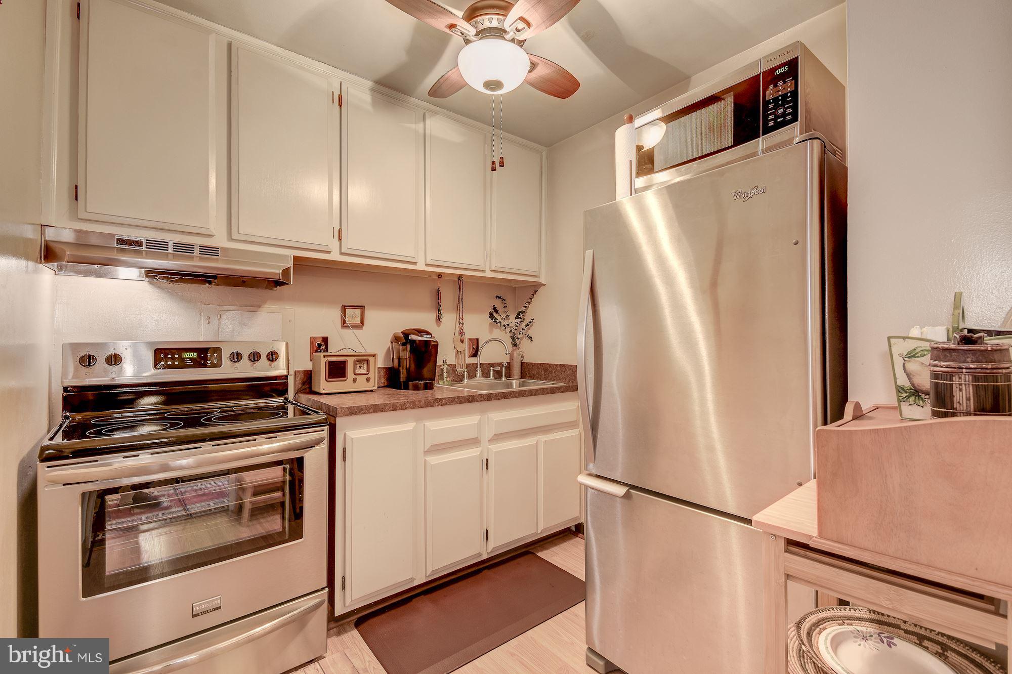 1425 4th Street Southwest, Unit 317 Washington, DC 20024 - Photo 4 of 23 a kitchen with stainless steel appliances a refrigerator sink and cabinets