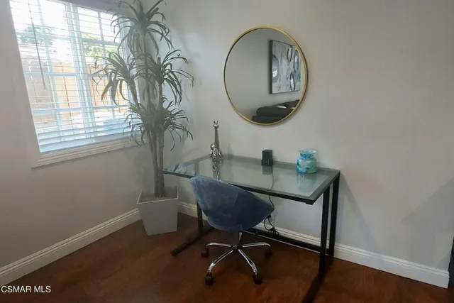 a workspace with furniture and a window