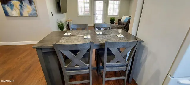 a view of a dining room with furniture and window