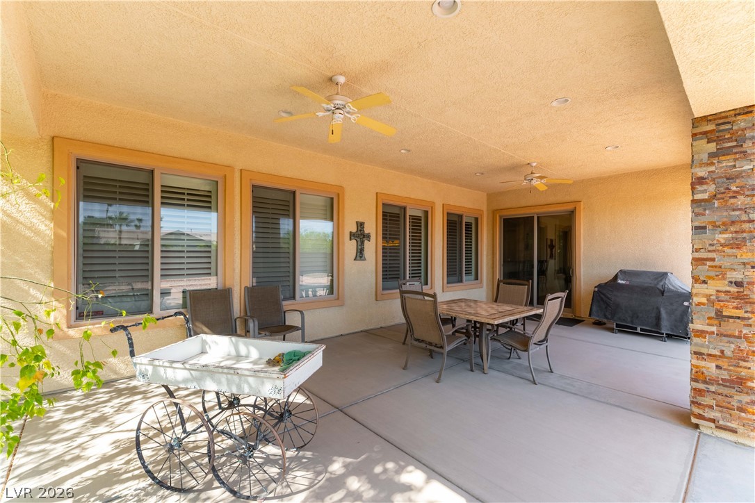 3661 Riley Ann Avenue Las Vegas, NV 89139 - Photo 33 of 42 An inviting covered patio features ceiling fans and ample space for outdoor dining and entertainment.