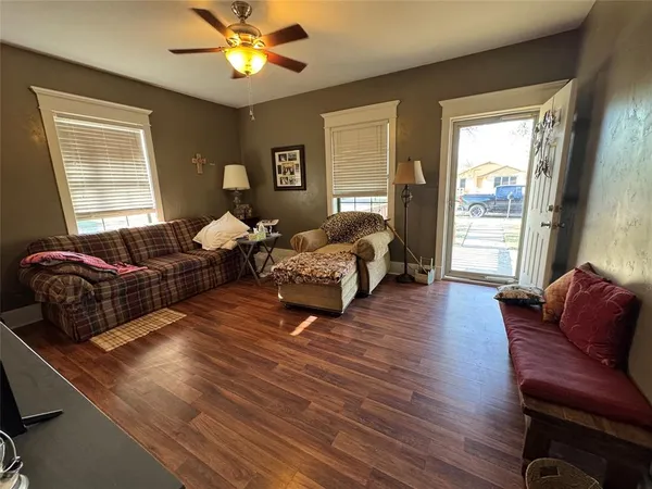 a living room with furniture chandelier and a window