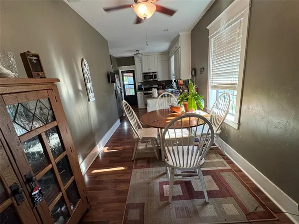 a dining room with furniture and window