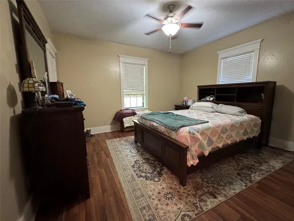 a bedroom with a bed lamp and a dresser