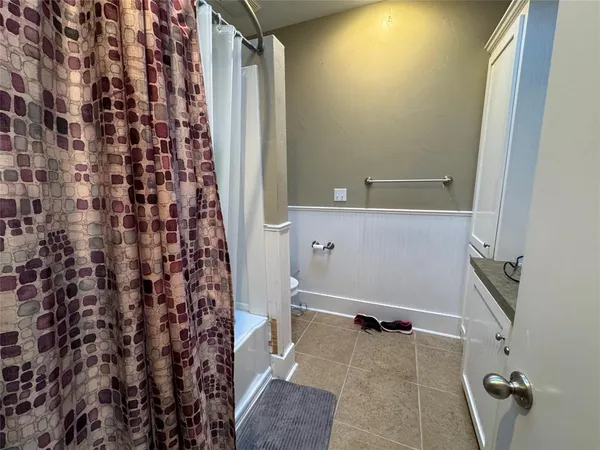 a bathroom with a shower and a toilet