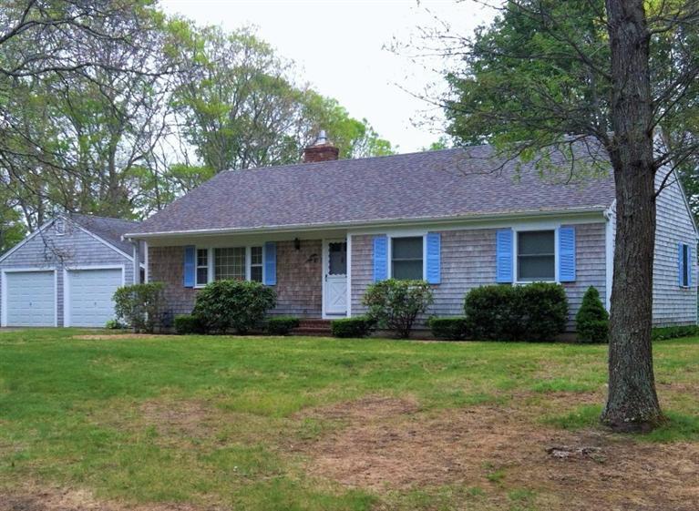 33 Goose Point Road Centerville, MA 02601 - Photo 1 of 29 a front view of a house with garden and trees