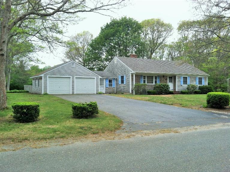 33 Goose Point Road Centerville, MA 02601 - Photo 2 of 29 a front view of a house with a garden