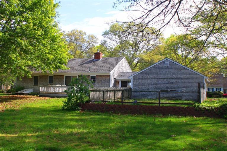 33 Goose Point Road Centerville, MA 02601 - Photo 24 of 29 a view of a house with a yard and a large tree