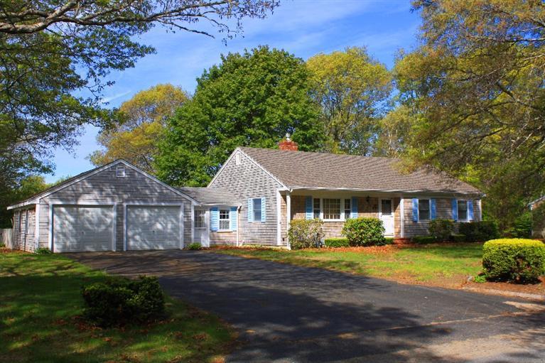 33 Goose Point Road Centerville, MA 02601 - Photo 3 of 29 a front view of a house with a garden