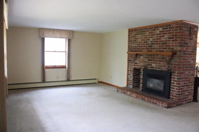 33 Goose Point Road Centerville, MA 02601 - Photo 5 of 29 a view of an empty room with a fireplace and a window