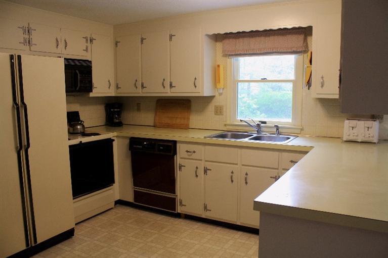 33 Goose Point Road Centerville, MA 02601 - Photo 10 of 29 a kitchen with stainless steel appliances cabinets a sink and a window