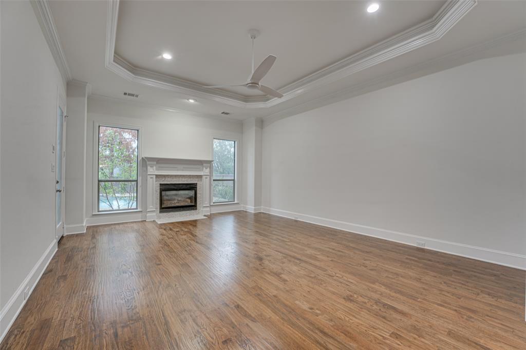 2216 Kings Pass Heath, TX 75032 - Photo 14 of 40 Master bedroom suite with fireplace & wood floors