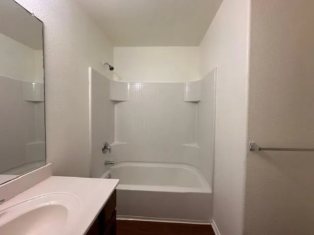 a view of an empty room with a ceiling fan