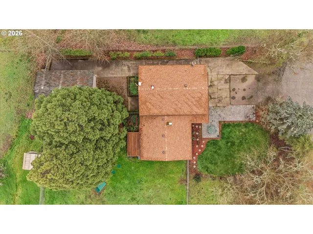 an aerial view of a house with a garden and yard