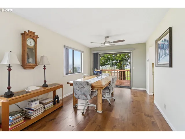 a dining room with wooden floor and a window