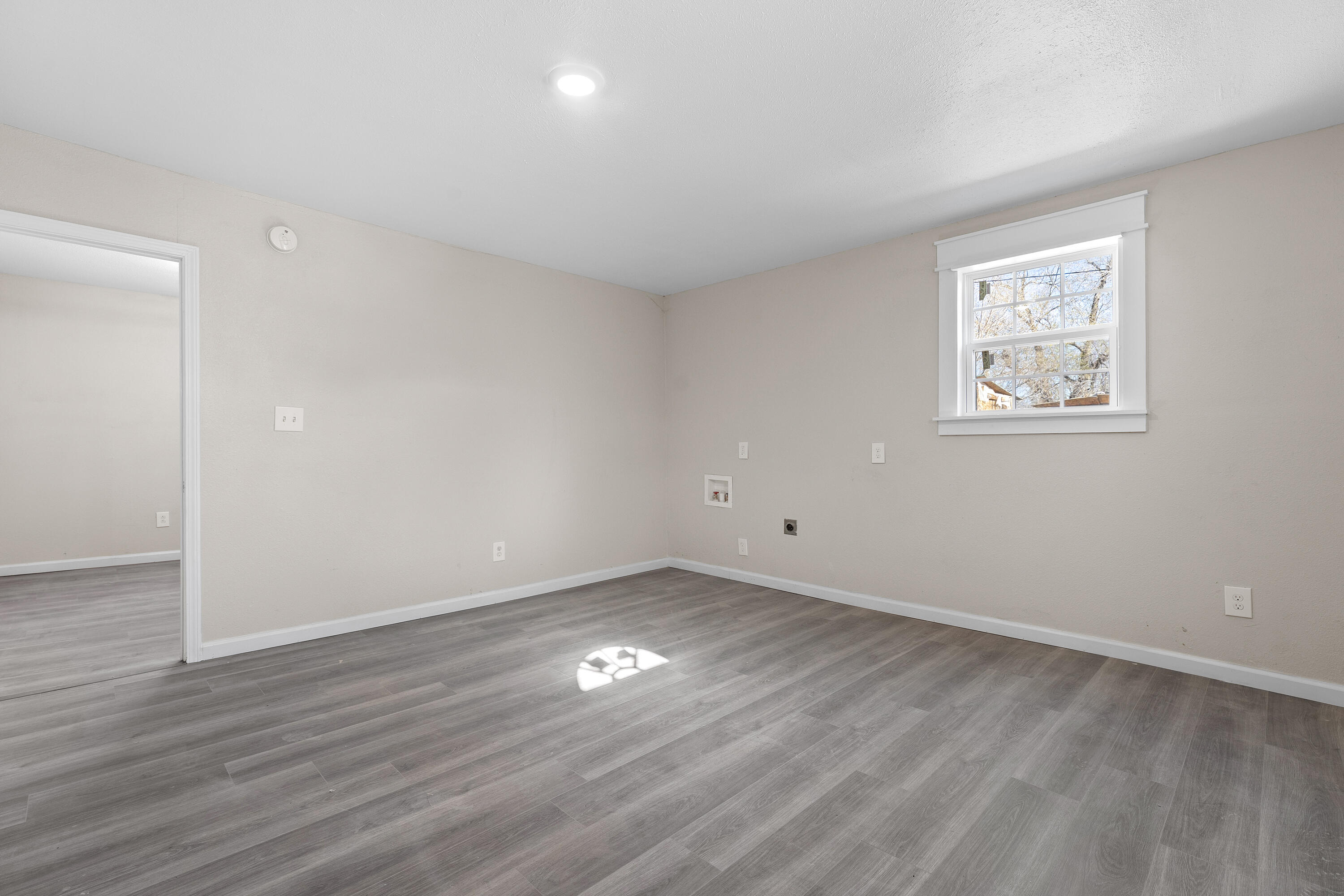 4820 39th Street Lubbock, TX 79414 - Photo 16 of 21 a view of an empty room with wooden floor and a window