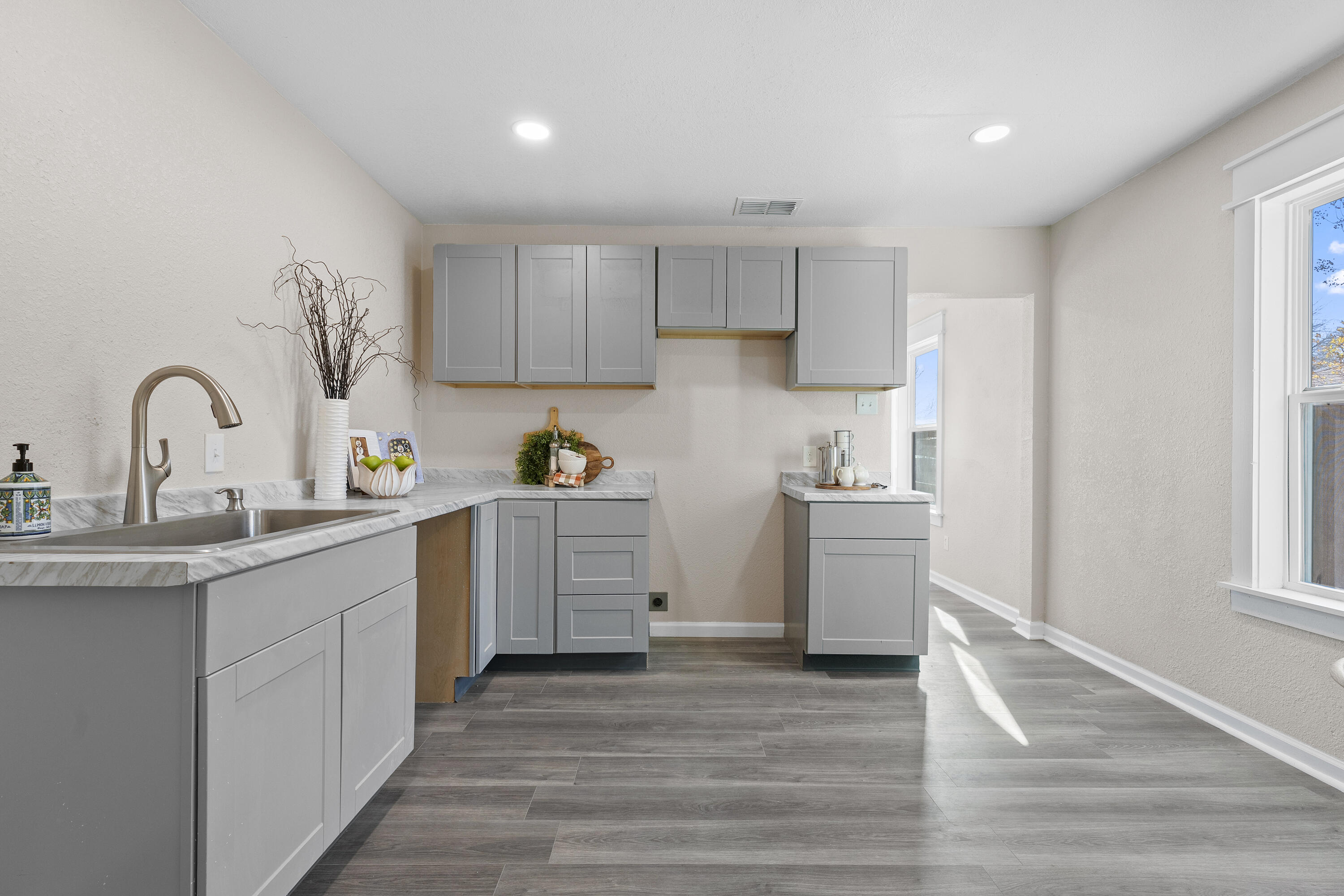 4820 39th Street Lubbock, TX 79414 - Photo 6 of 21 a kitchen with a sink cabinets and wooden floor