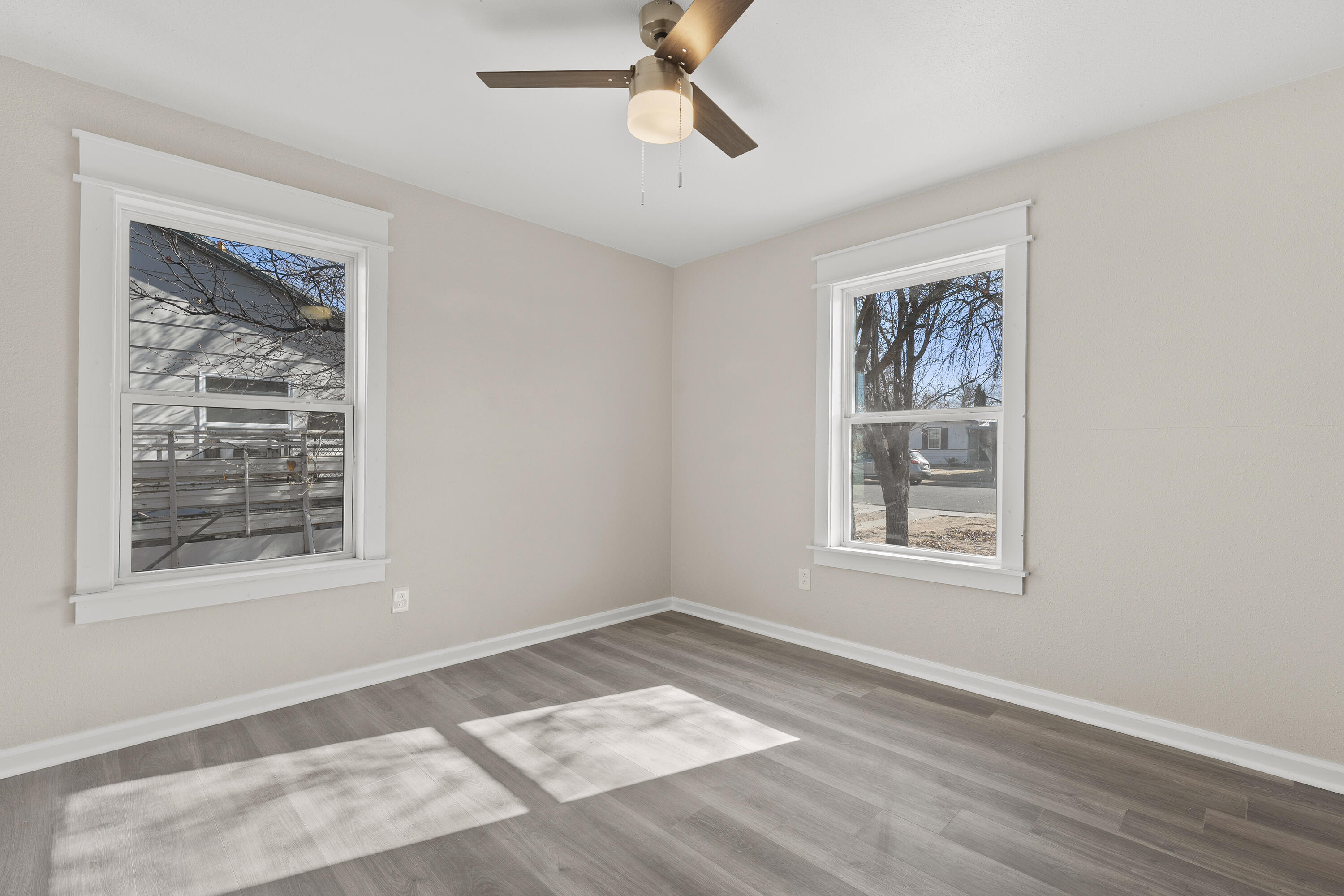 4820 39th Street Lubbock, TX 79414 - Photo 7 of 21 a view of an empty room with a window and wooden floor