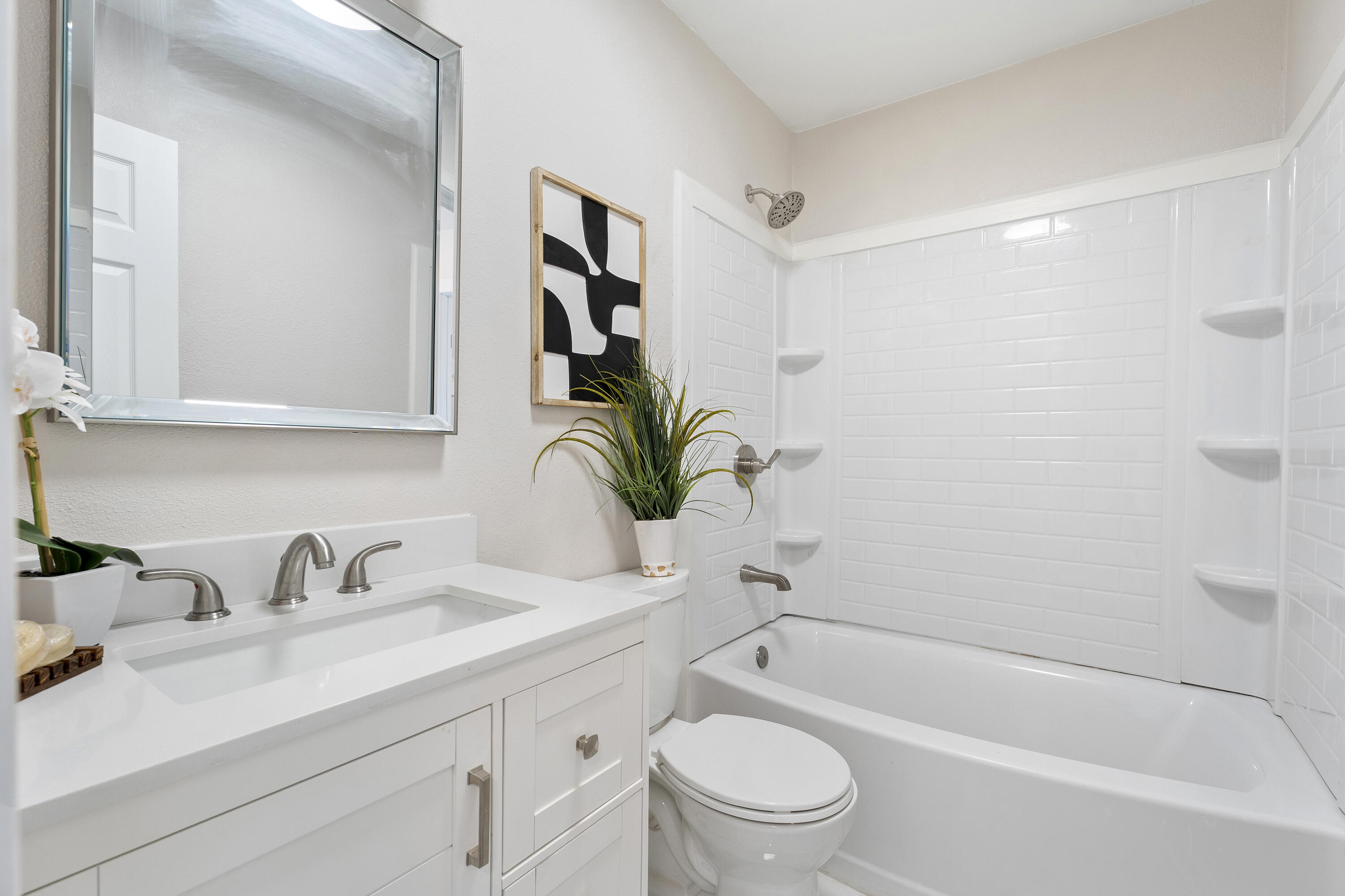 4820 39th Street Lubbock, TX 79414 - Photo 9 of 21 a bathroom with a granite countertop sink a toilet and a bathtub