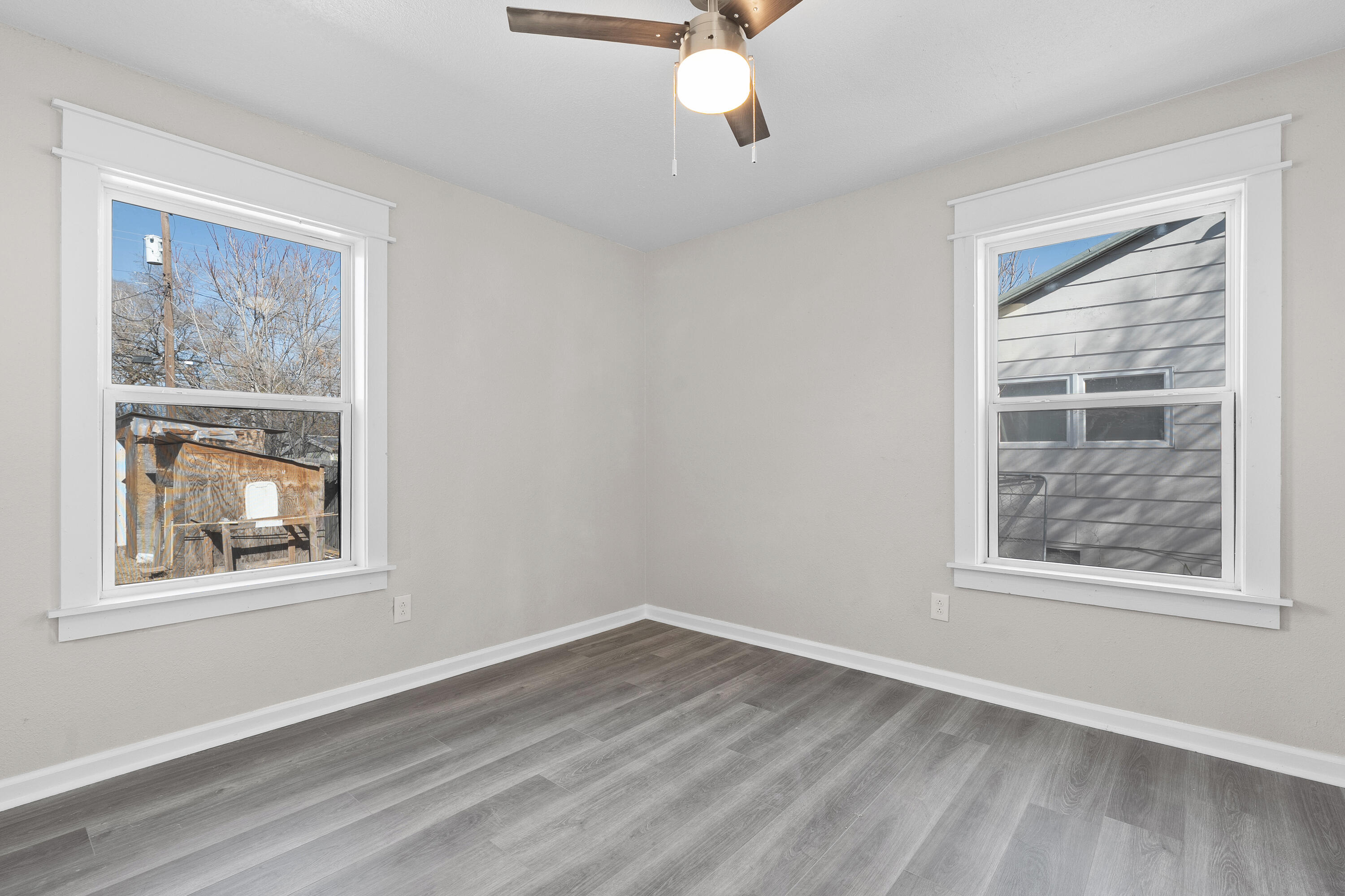 4820 39th Street Lubbock, TX 79414 - Photo 10 of 21 a view of an empty room with wooden floor and a window