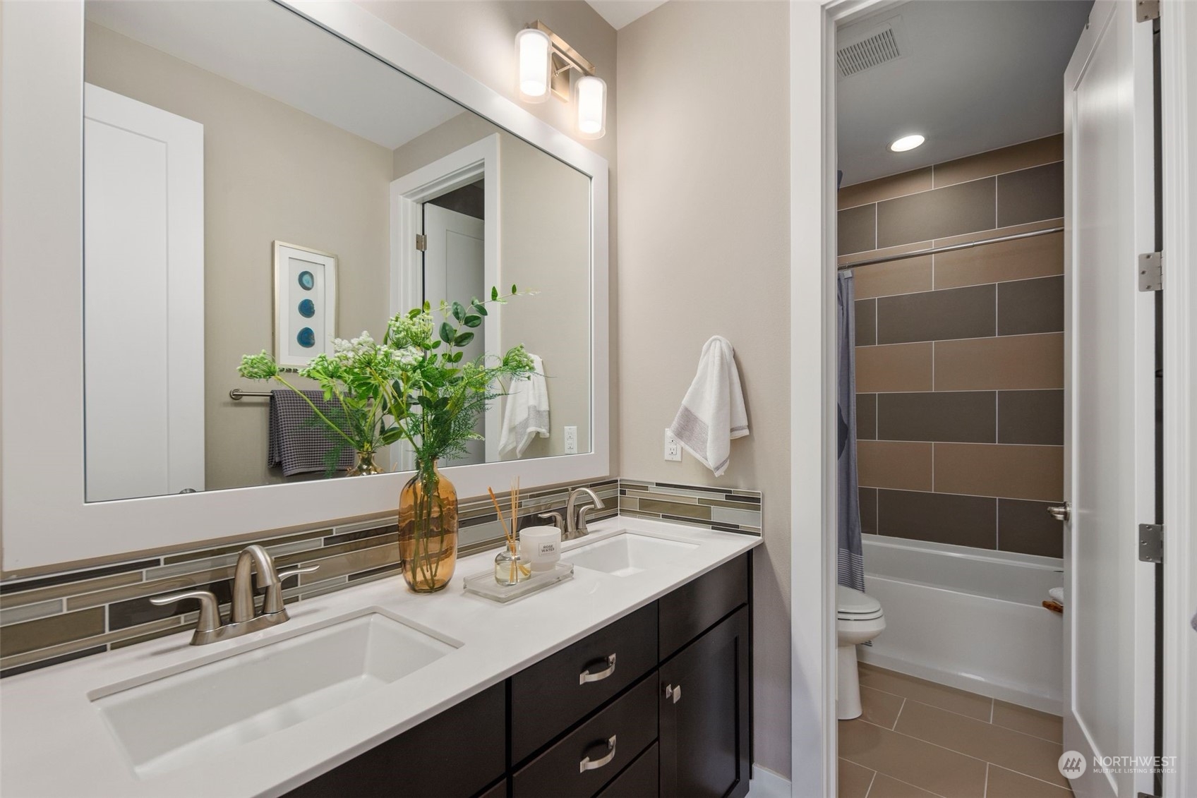 263 Graham Avenue Southeast Renton, WA 98059 - Photo 28 of 40 a bathroom with a double vanity sink a toilet and a mirror