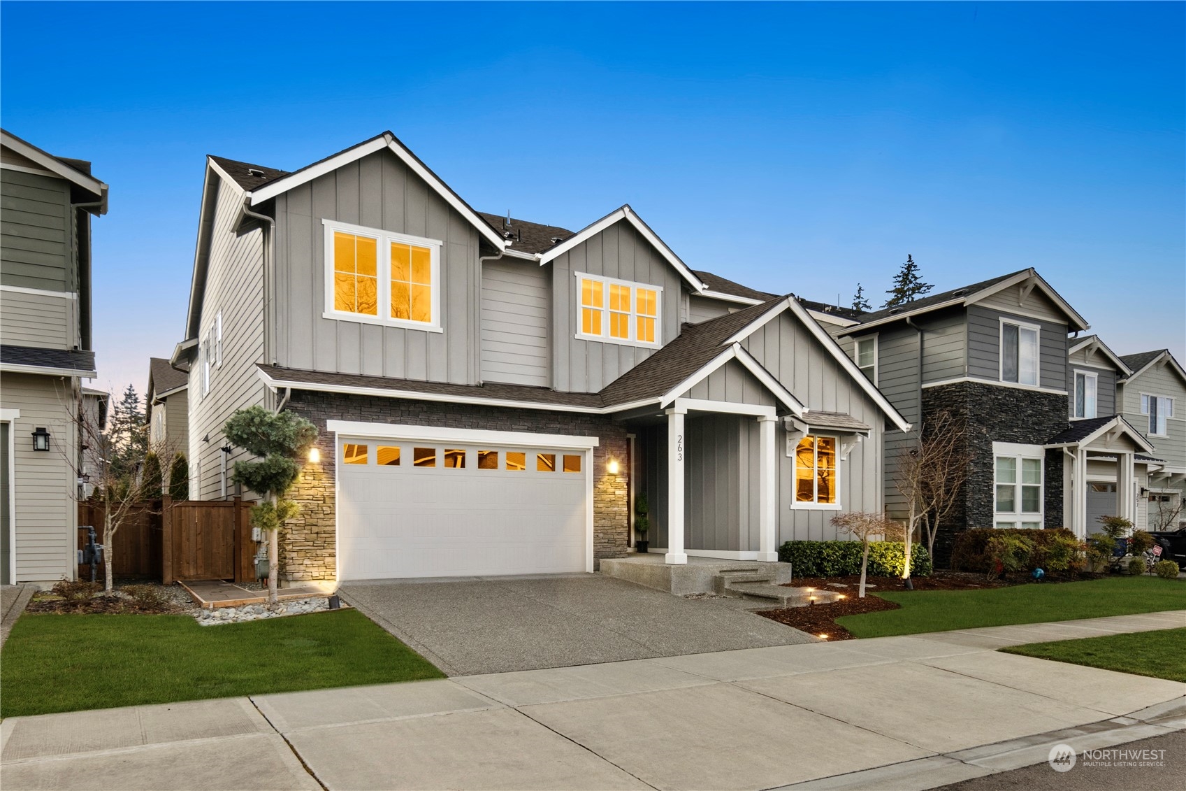 263 Graham Avenue Southeast Renton, WA 98059 - Photo 31 of 40 a front view of a house with a yard and garage