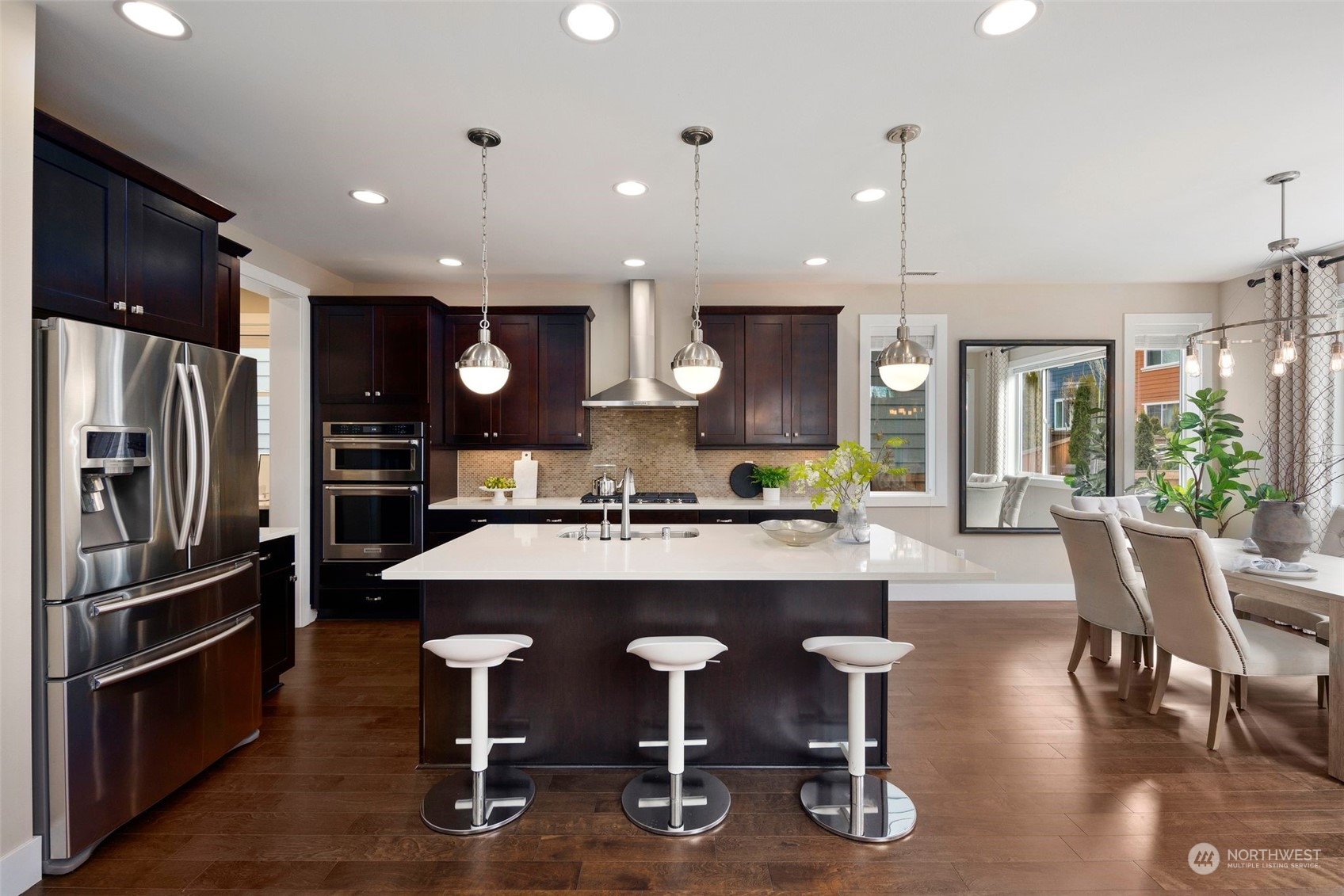 263 Graham Avenue Southeast Renton, WA 98059 - Photo 8 of 40 a kitchen with stainless steel appliances granite countertop a table chairs refrigerator and sink