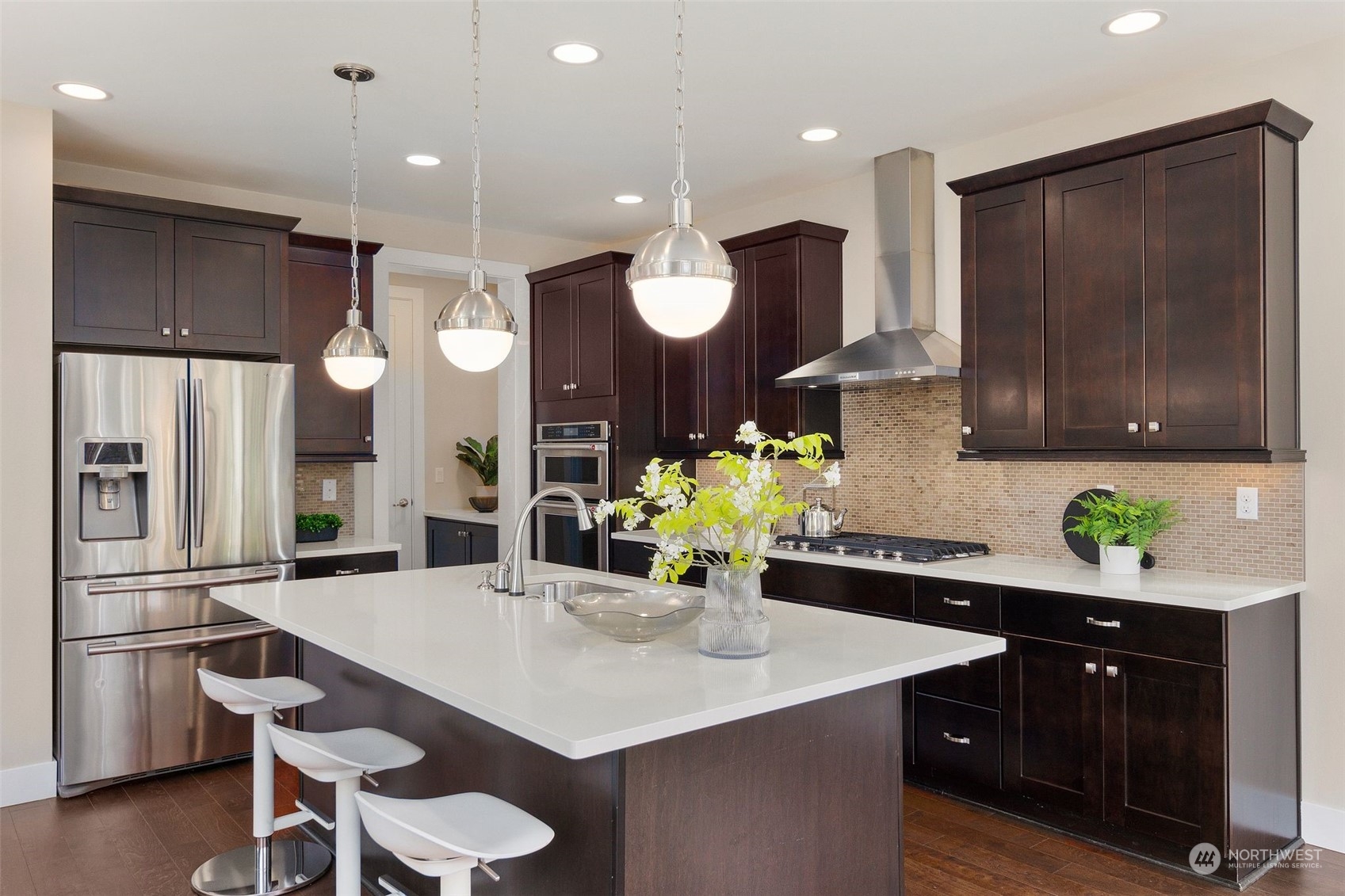 263 Graham Avenue Southeast Renton, WA 98059 - Photo 10 of 40 a kitchen with stainless steel appliances a dining table chairs and refrigerator
