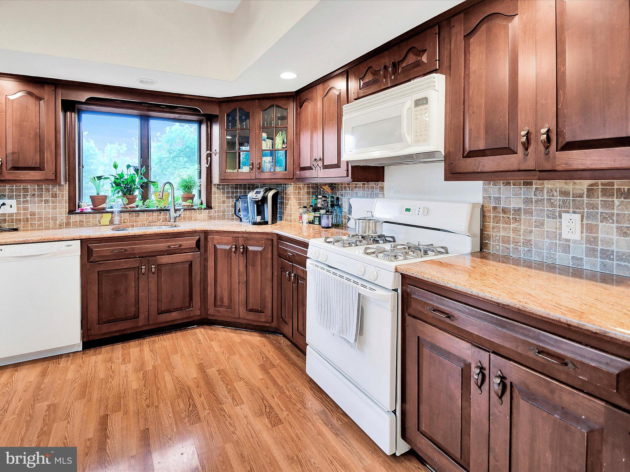 3 Bells Mill Road Glenside, PA 19038 - Photo 12 of 38 a kitchen with a sink stove and cabinets