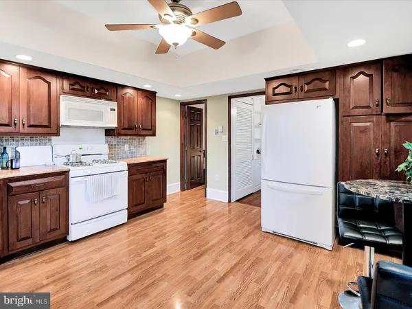 a kitchen with stainless steel appliances a refrigerator sink and microwave